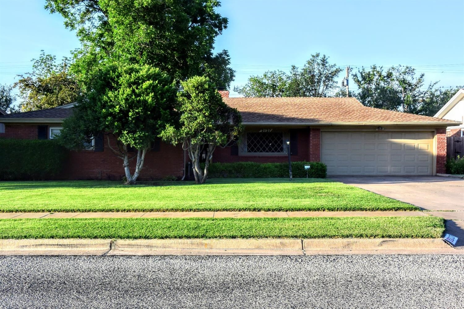 2127 52nd Street Lubbock, TX 79412 - Photo 2 of 10 a front view of a house with a garden