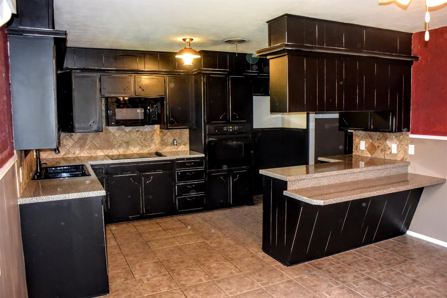 2127 52nd Street Lubbock, TX 79412 - Photo 6 of 10 a kitchen with a sink and a refrigerator