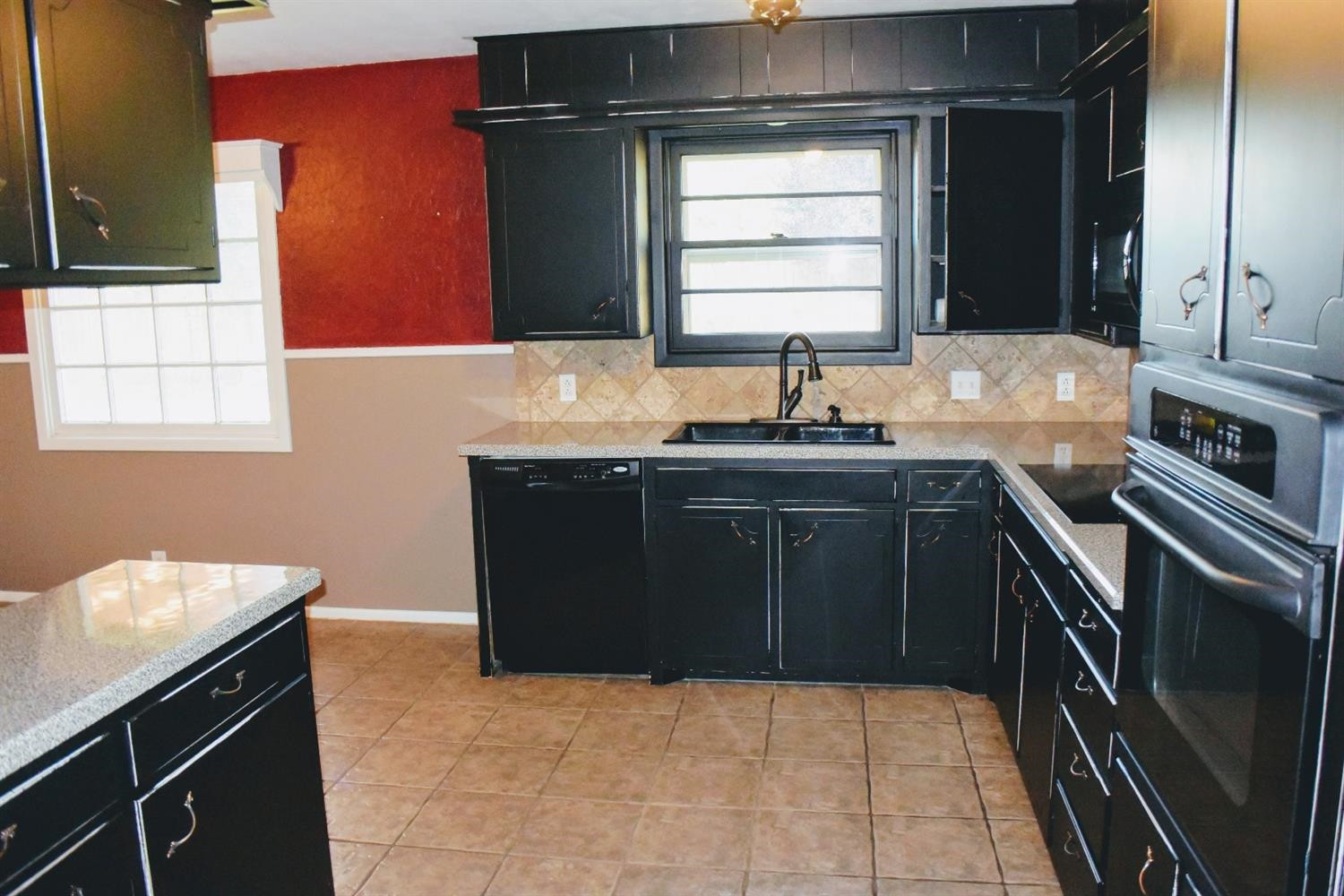 2127 52nd Street Lubbock, TX 79412 - Photo 7 of 10 a kitchen with a sink a stove and cabinets