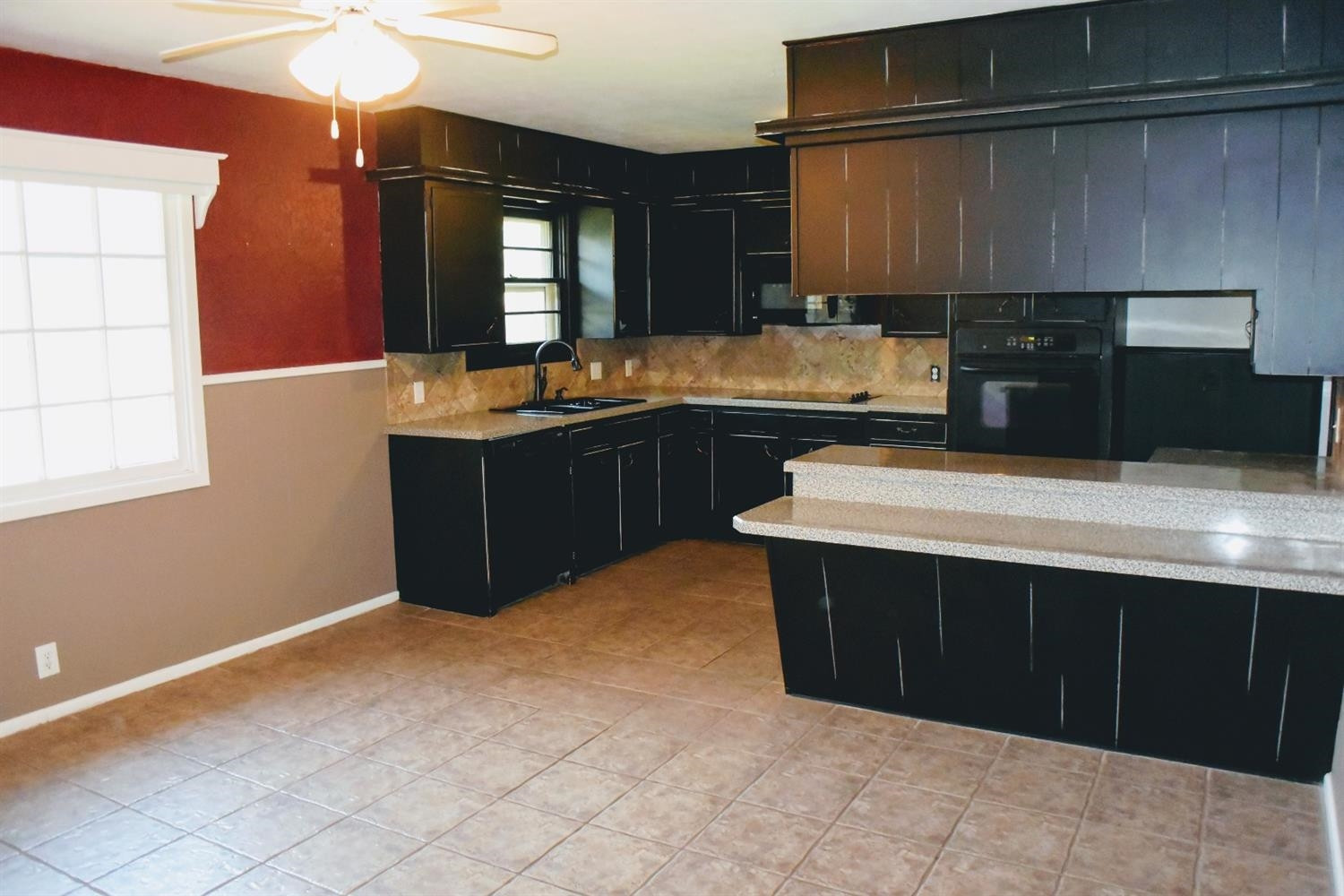 2127 52nd Street Lubbock, TX 79412 - Photo 8 of 10 a kitchen with stainless steel appliances a sink and a stove
