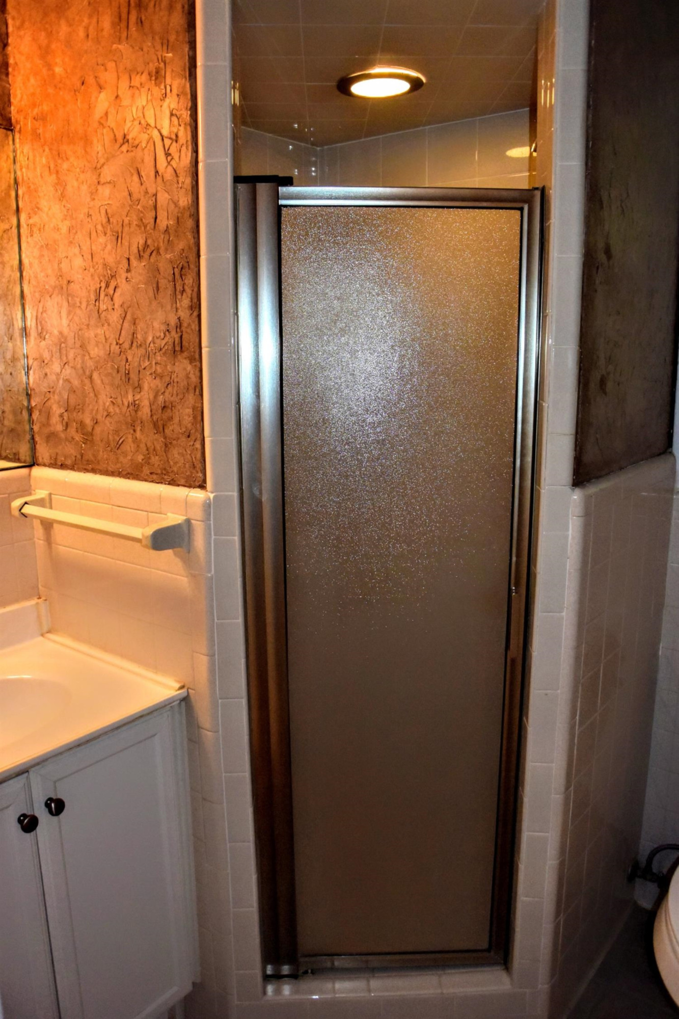 2127 52nd Street Lubbock, TX 79412 - Photo 10 of 10 a bathroom with a glass shower door