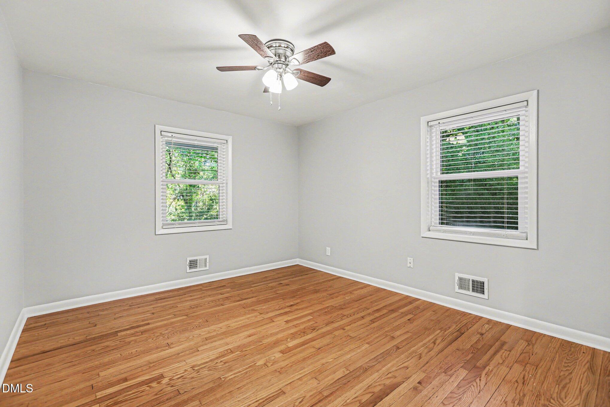 2600 Wade Avenue Raleigh, NC 27607 - Photo 12 of 31 a view of an empty room with wooden floor and a window