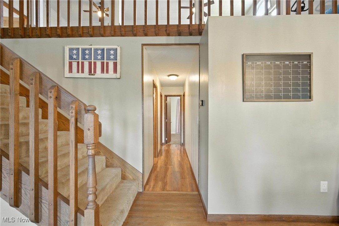 1371 Spider Ridge Road Parkersburg, WV 26104 - Photo 16 of 48 Stairway featuring wood finished floors and a high ceiling