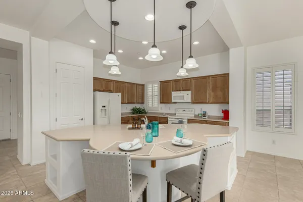 a kitchen with refrigerator and microwave