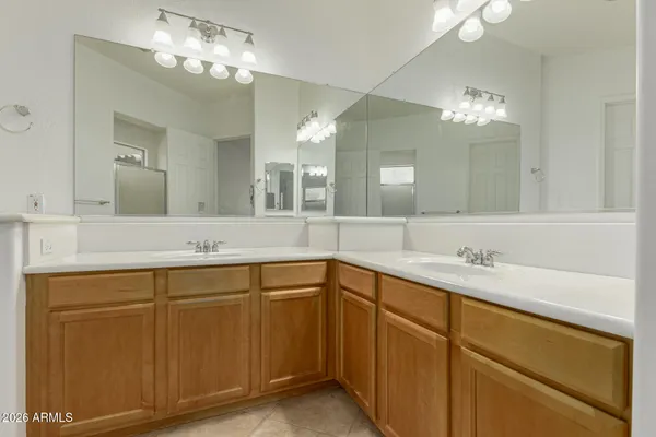 a bathroom with a double vanity sink and a mirror