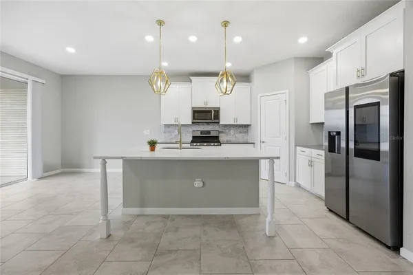 a large kitchen with cabinets and stainless steel appliances