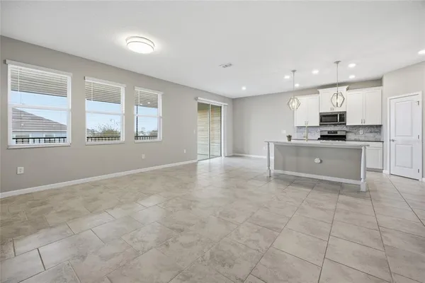 a view of kitchen with granite countertop cabinets and window