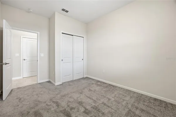 an empty room with closet area