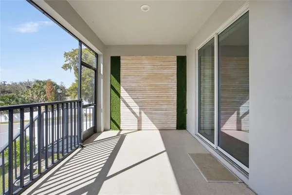 a view of a house with a yard from a balcony