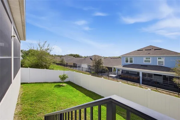 a view of backyard with small cabin and wooden fence