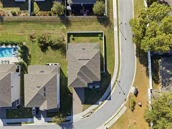 an aerial view of a house with a swimming pool