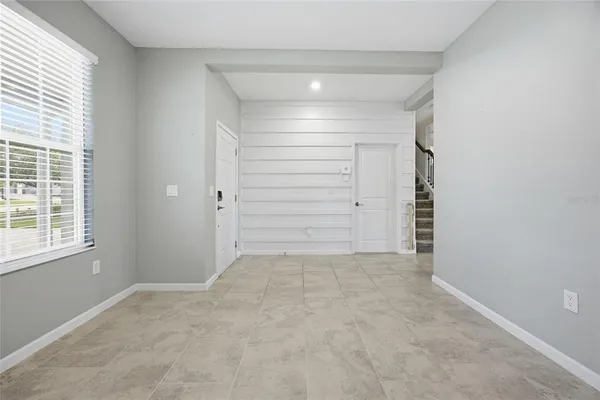 an empty room with closet and windows