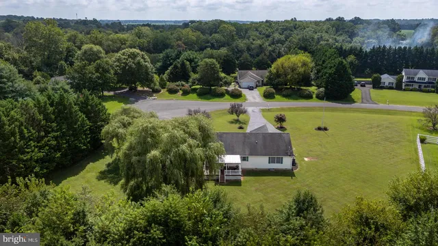 an aerial view of a house with a yard swimming pool outdoor seating yard and mountain view