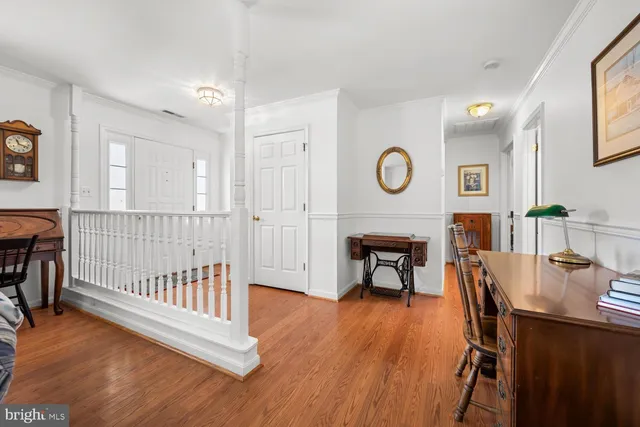 a view of a room with wooden floor and windows