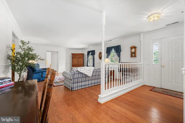 a bedroom with furniture and wooden floor