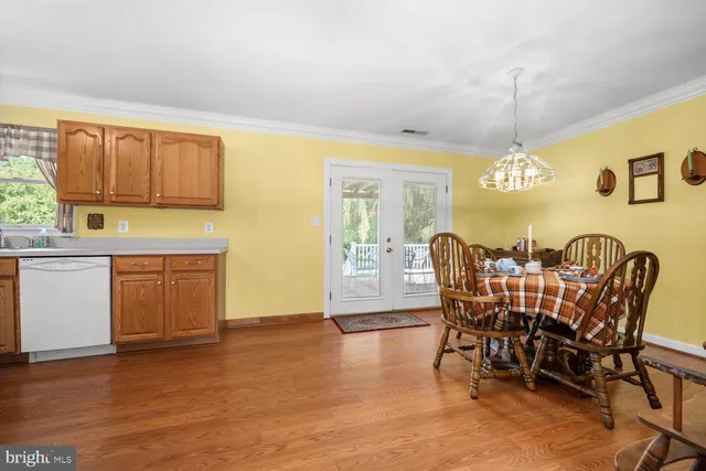 a view of a dining room with furniture and chandelier
