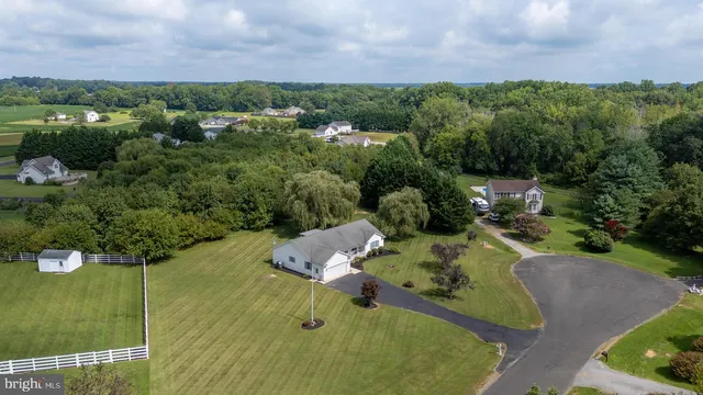 an aerial view of a house with a yard basket ball court and outdoor seating