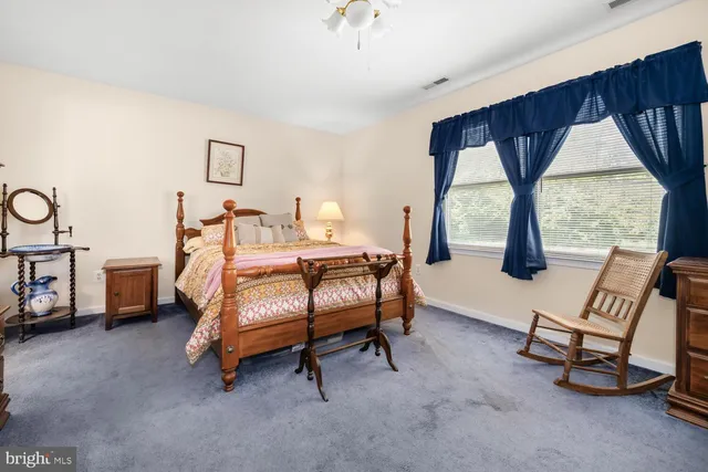 a bedroom with furniture and a window