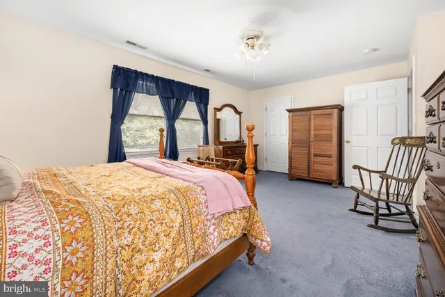 a bed room with a bed and a chair