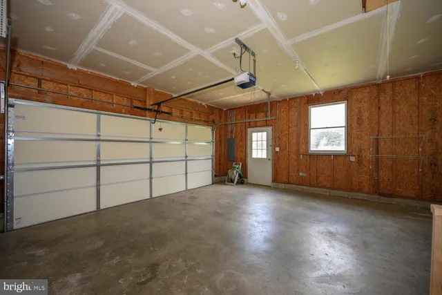 a view of a patio with a table chairs and wooden floor