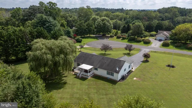 an aerial view of a house with pool outdoor seating and yard
