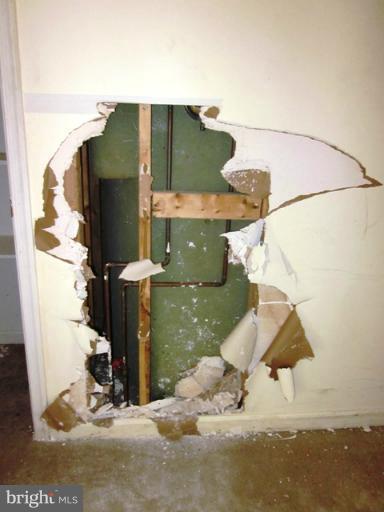 9727 Eustice Road Randallstown, MD 21133 - Photo 13 of 29 Living Room hole in wall