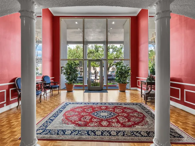 a living room with furniture and a floor to ceiling window