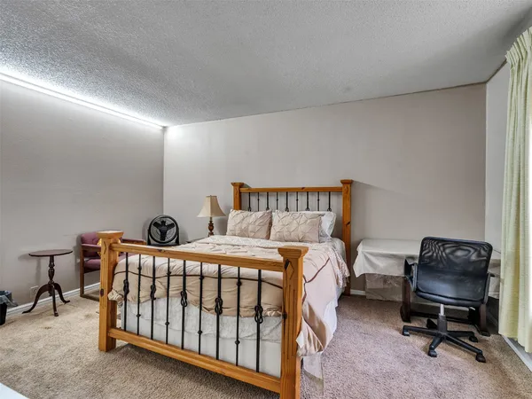 a bedroom with a bed and a chair