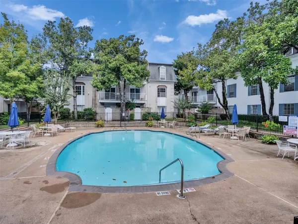 a swimming pool with outdoor seating and yard
