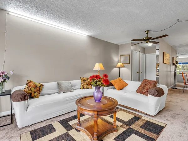a living room with furniture and flowers