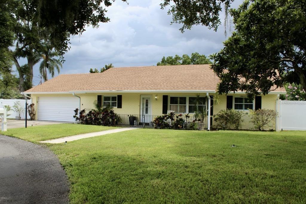 a front view of a house with a garden and porch