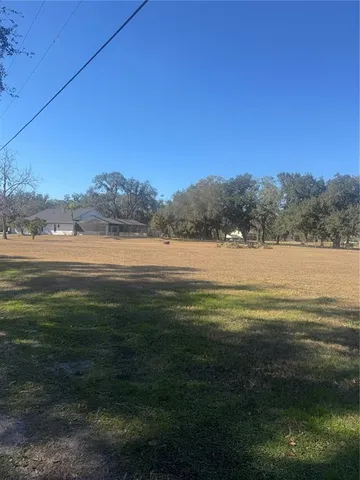 a view of a field with mountains in the background
