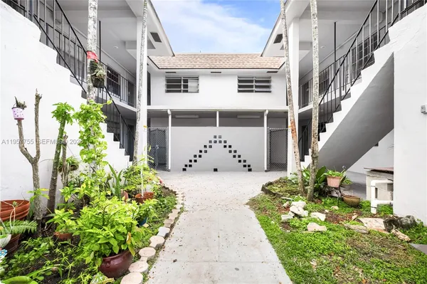 a view of a house with potted plants
