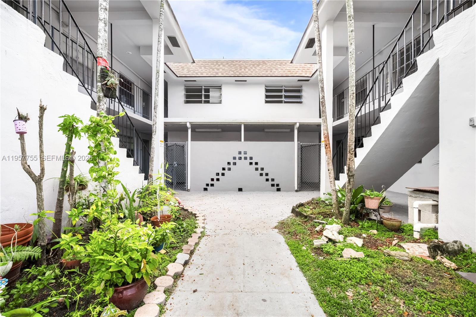 10375-35-55 Southwest 40th Street Miami, FL 33165 - Photo 1 of 13 a view of a house with potted plants
