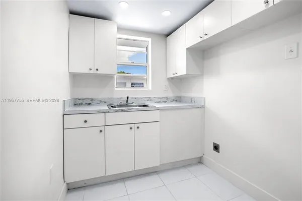 a kitchen with white cabinets