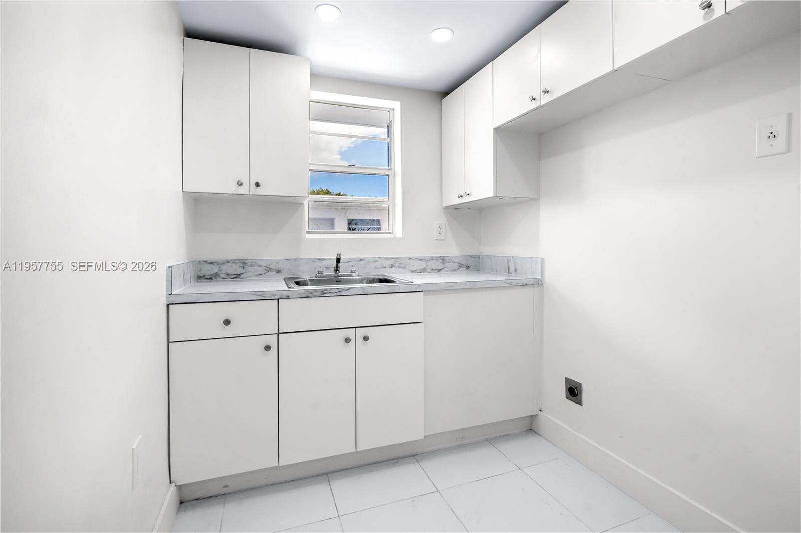 10375-35-55 Southwest 40th Street Miami, FL 33165 - Photo 6 of 13 a kitchen with white cabinets