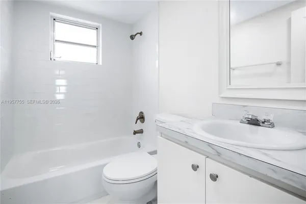 a bathroom with a sink a toilet and a bathtub