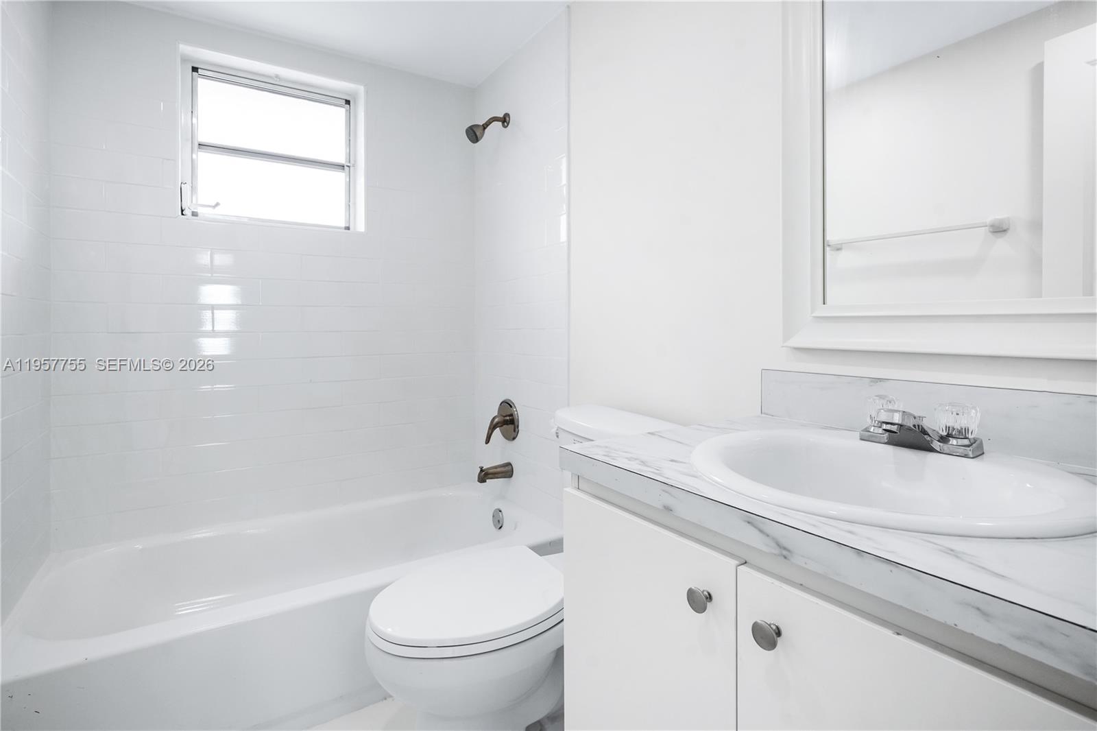 10375-35-55 Southwest 40th Street Miami, FL 33165 - Photo 7 of 13 a bathroom with a sink a toilet and a bathtub