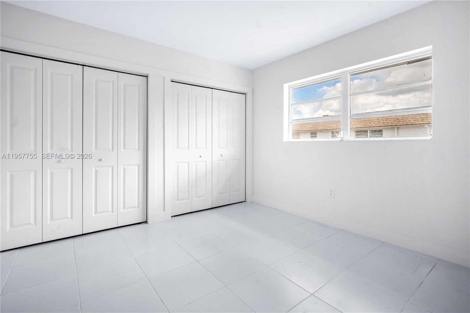 10375-35-55 Southwest 40th Street Miami, FL 33165 - Photo 9 of 13 an empty room with windows