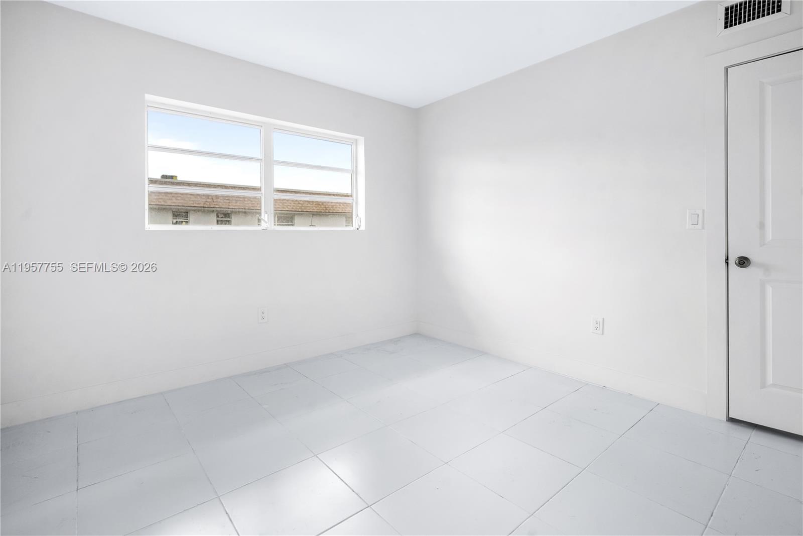10375-35-55 Southwest 40th Street Miami, FL 33165 - Photo 10 of 13 an empty room with a window