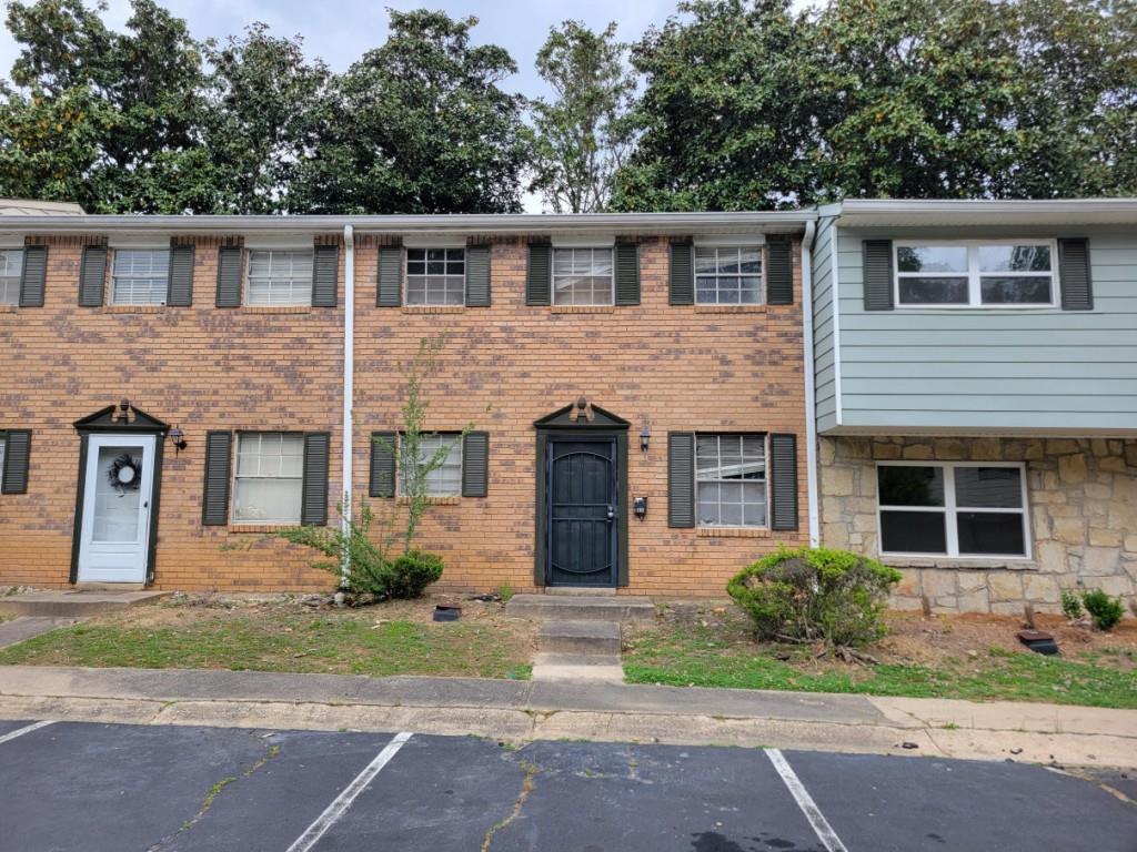 4701 Flat Shoals Road, Unit 56D Union City, GA 30291 - Photo 1 of 1 a front view of a house with a yard and a garage