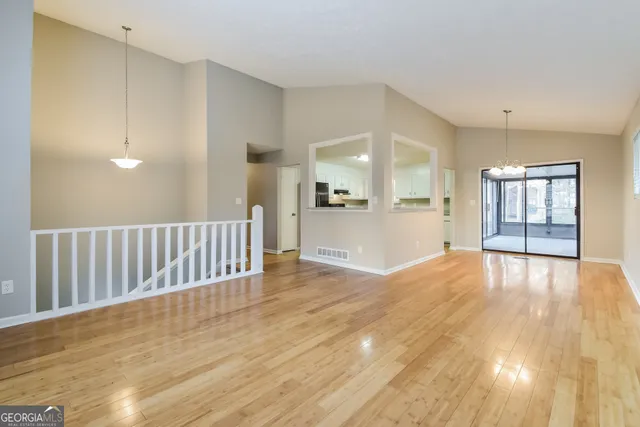 a view of an empty room and wooden floor