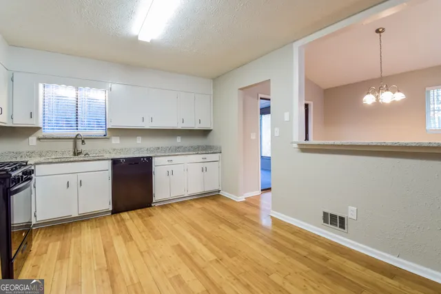 a kitchen with a sink cabinets and window