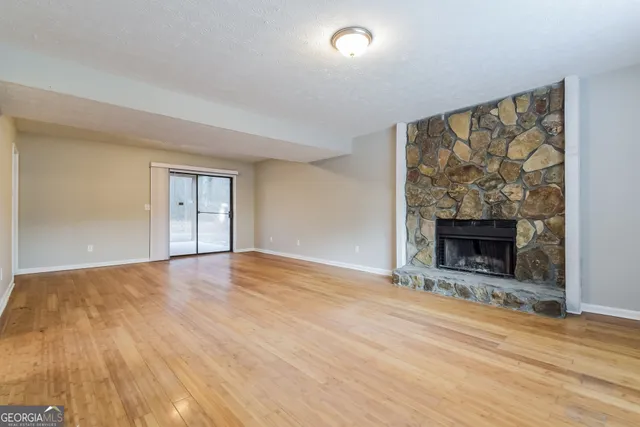 wooden floor fireplace and natural light in room
