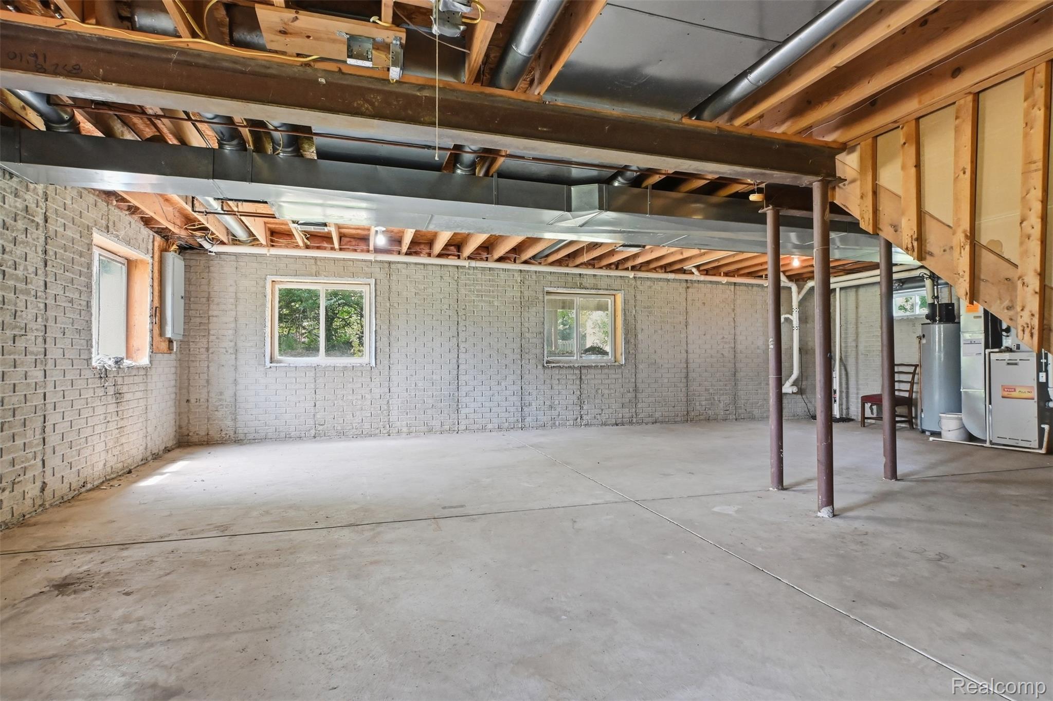 4482 Pleasant Valley Road Brighton, MI 48114 - Photo 23 of 35 Spacious lower level featuring exposed ceiling joists and concrete flooring