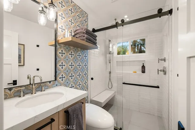 a bathroom with a sink toilet and shower