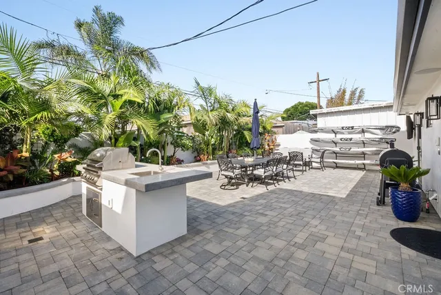 a view of a patio with table and chairs potted plants