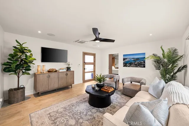 a living room with furniture and a potted plant