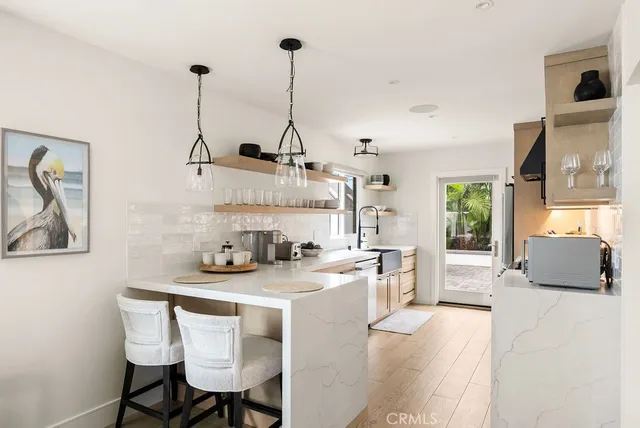 a view of a kitchen with furniture and a wooden floor