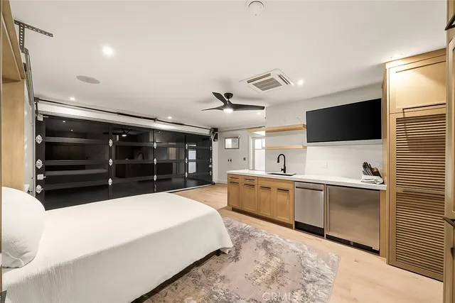 a large white kitchen with a large window